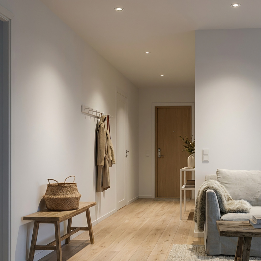 Gang som leder til stue belyst med innfelte downlights i taket.